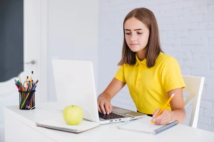 a girl is working on laptop in the office